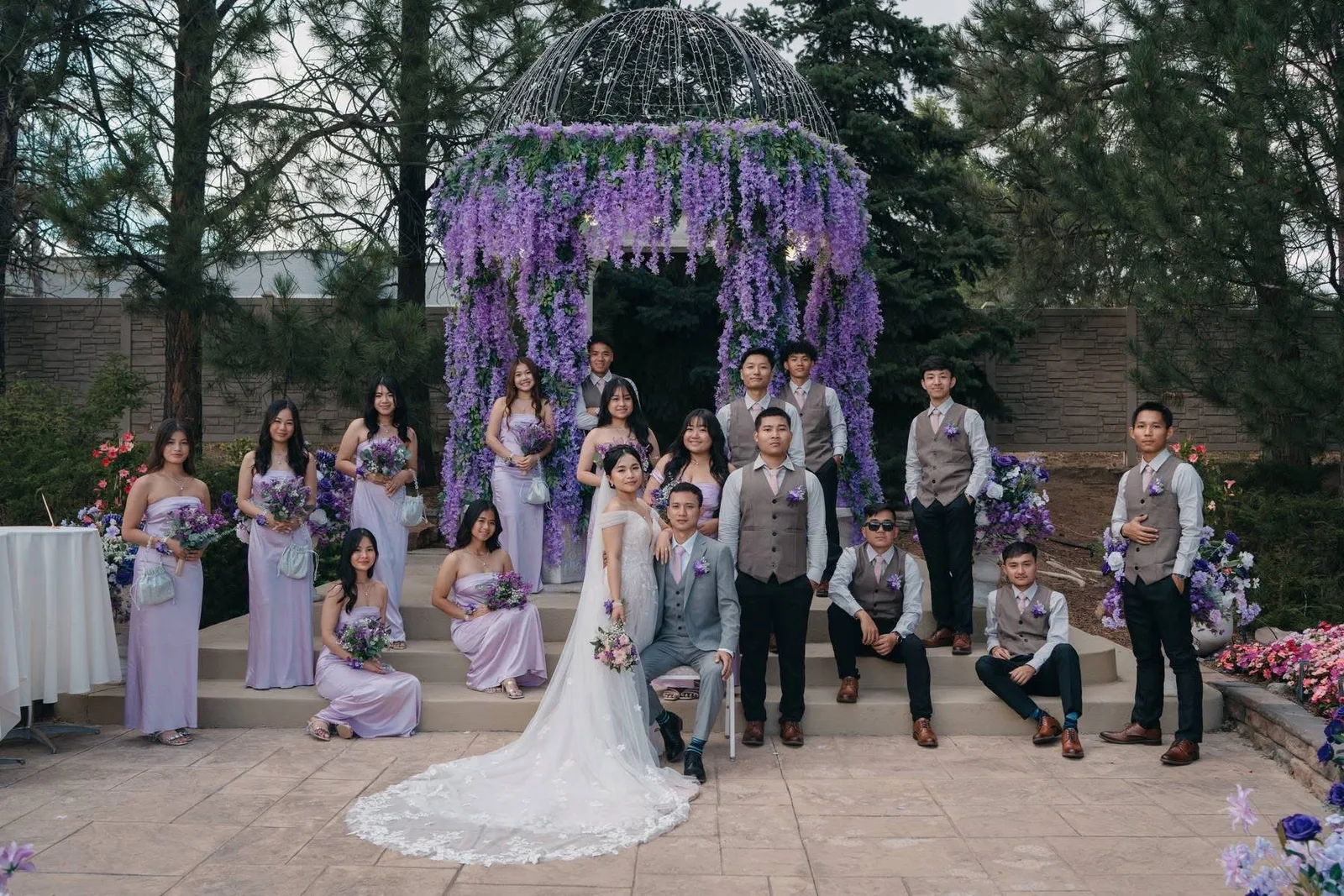 A wedding party gathered under the gazebo in the gardens